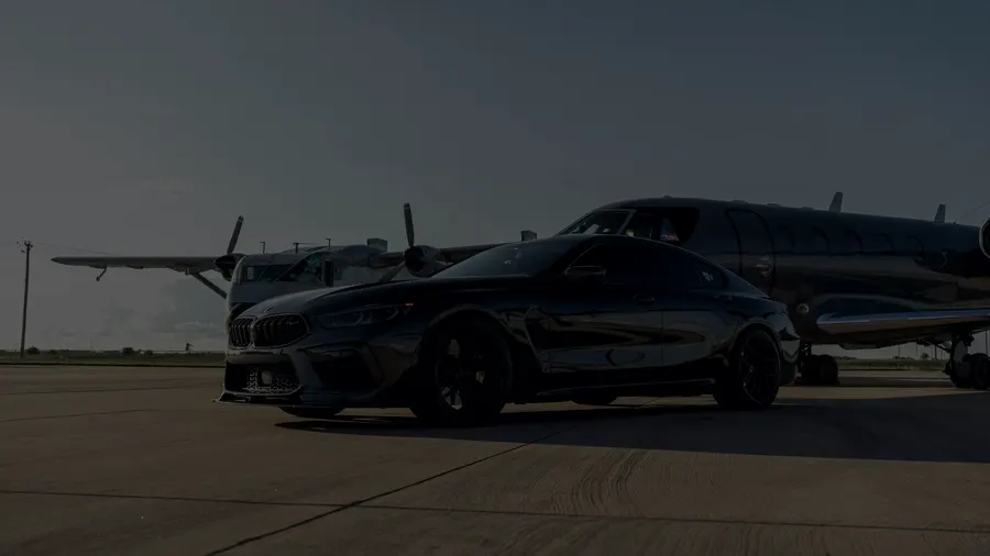 A car waiting beside a private jet on the tarmac